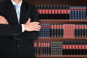 Law books lined up with Assault Defense Attorney in front